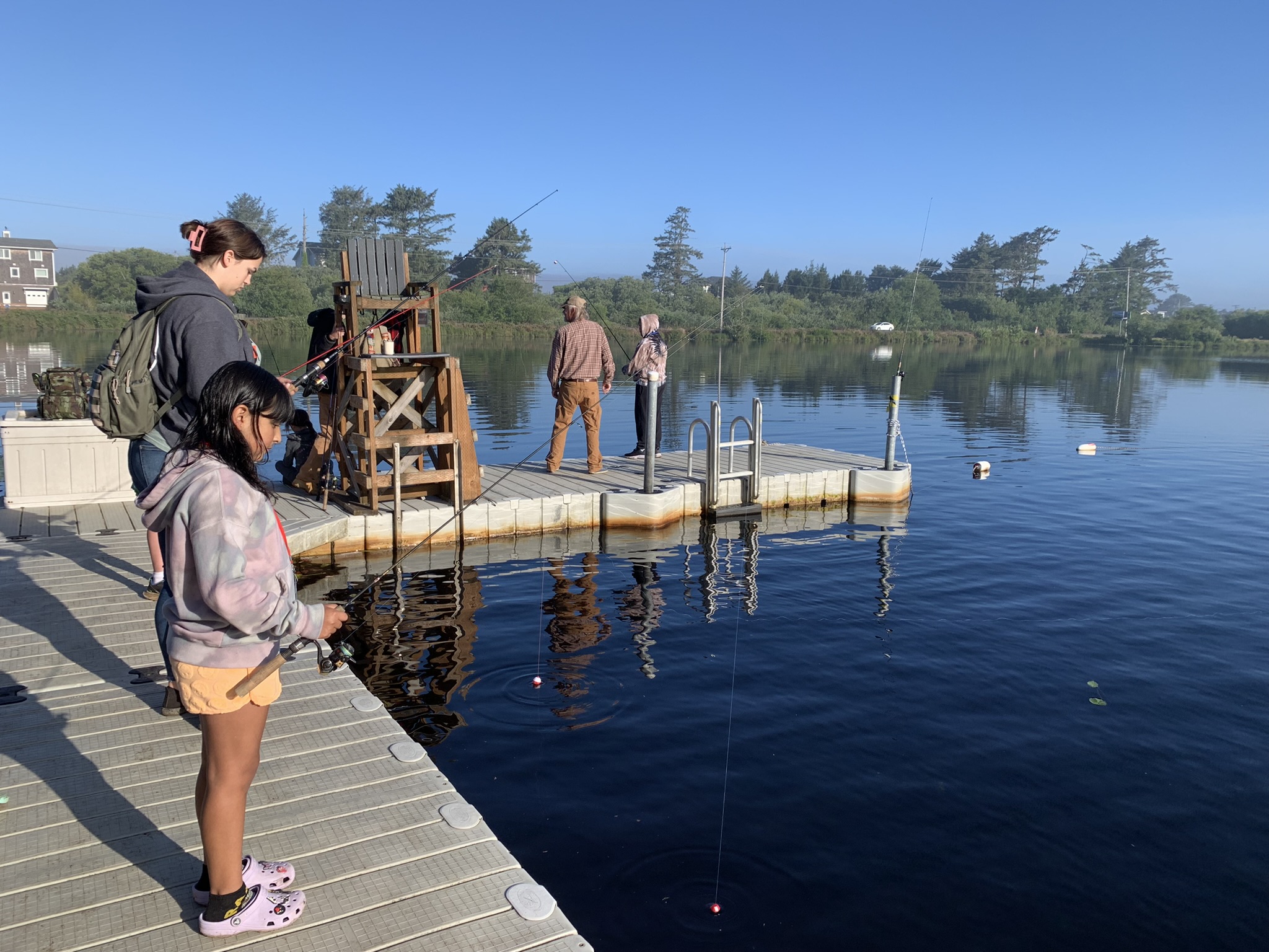 kids and counselor on the dock fishing